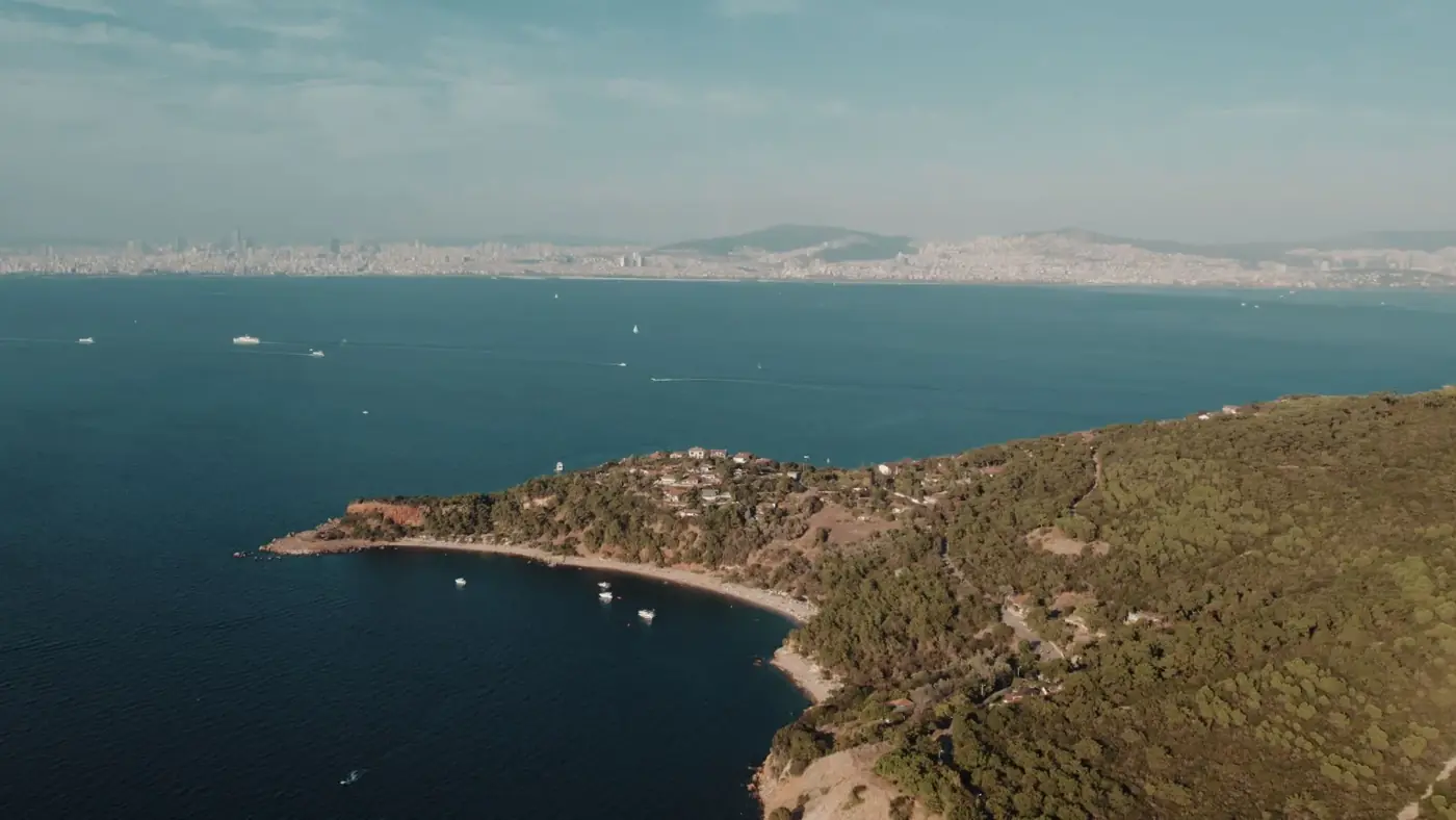 Scenic drone shot of Burgazada island with İstanbul skyline in the background, Türkiye.