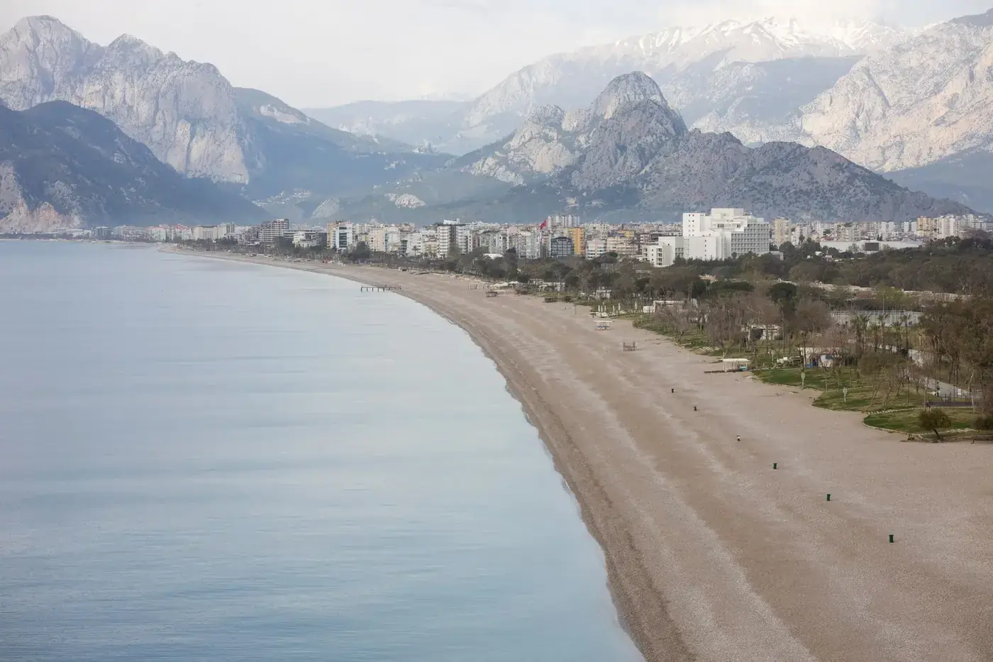 Peaceful beach in Antalya with the Taurus Mountains in the background.