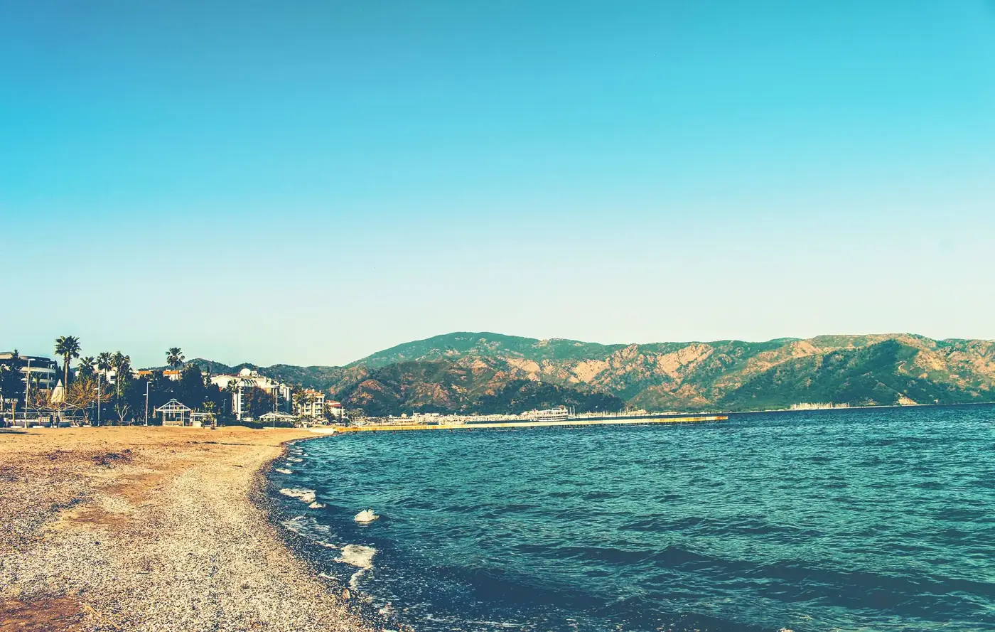 Beautiful sunny beach and mountain scenery in Marmaris, Turkey, perfect for summer travel.