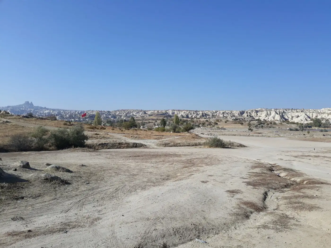 Idyllic view of dry landscape in Cappadocia, Turkey under clear blue sky.