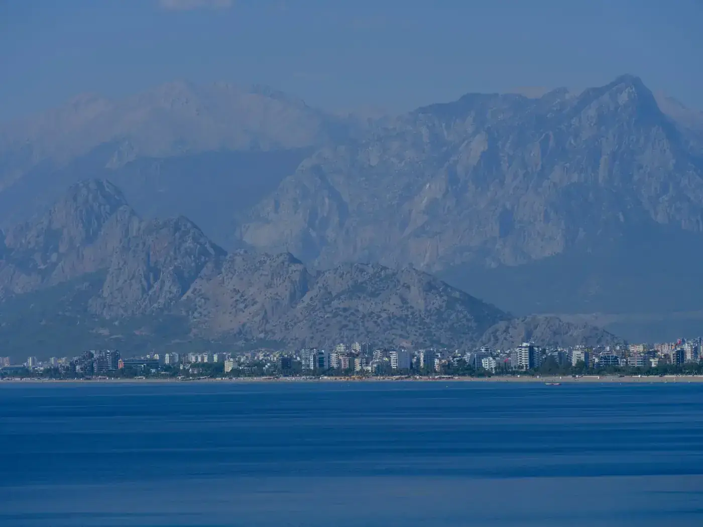 Peaceful view of Antalya city with impressive mountains and serene blue sea.