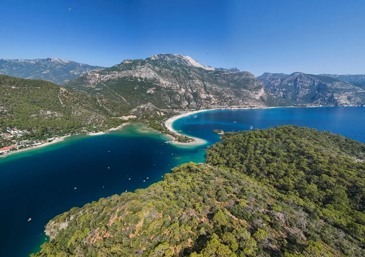 Stunning aerial view of the Blue Lagoon in Ölüdeniz, showcasing the turquoise waters and surrounding mountains in Muğla,