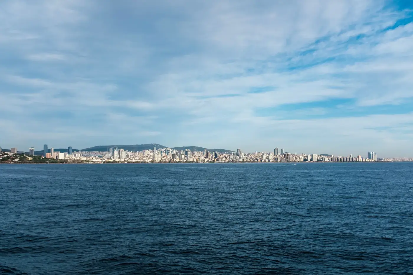A scenic view of Pendik skyline and the sea in İstanbul, showcasing urban architecture and a tranquil waterfront.