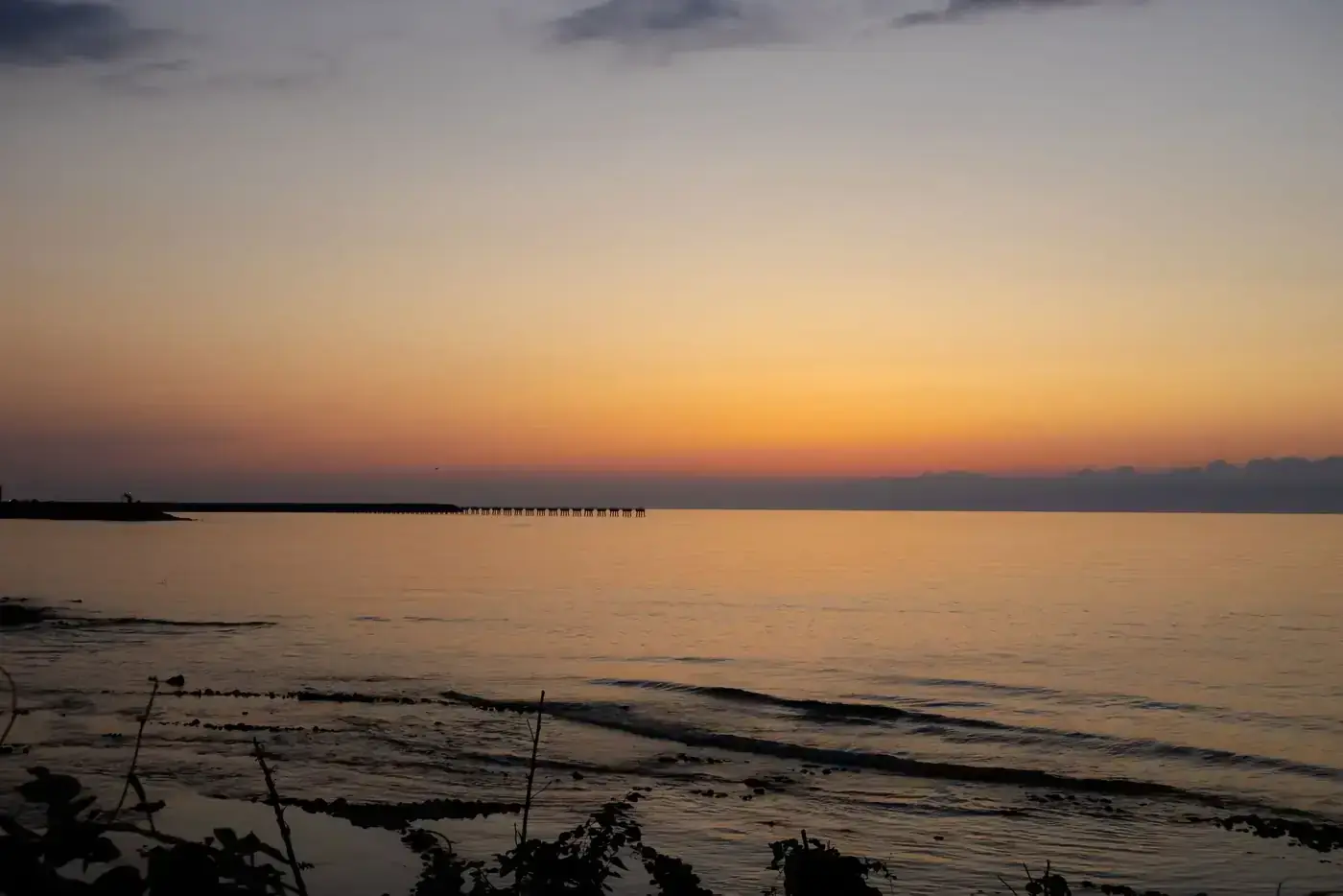 Tranquil scene of the sunset over Pazar coastline in Rize, Turkey with calm sea and vibrant sky.
