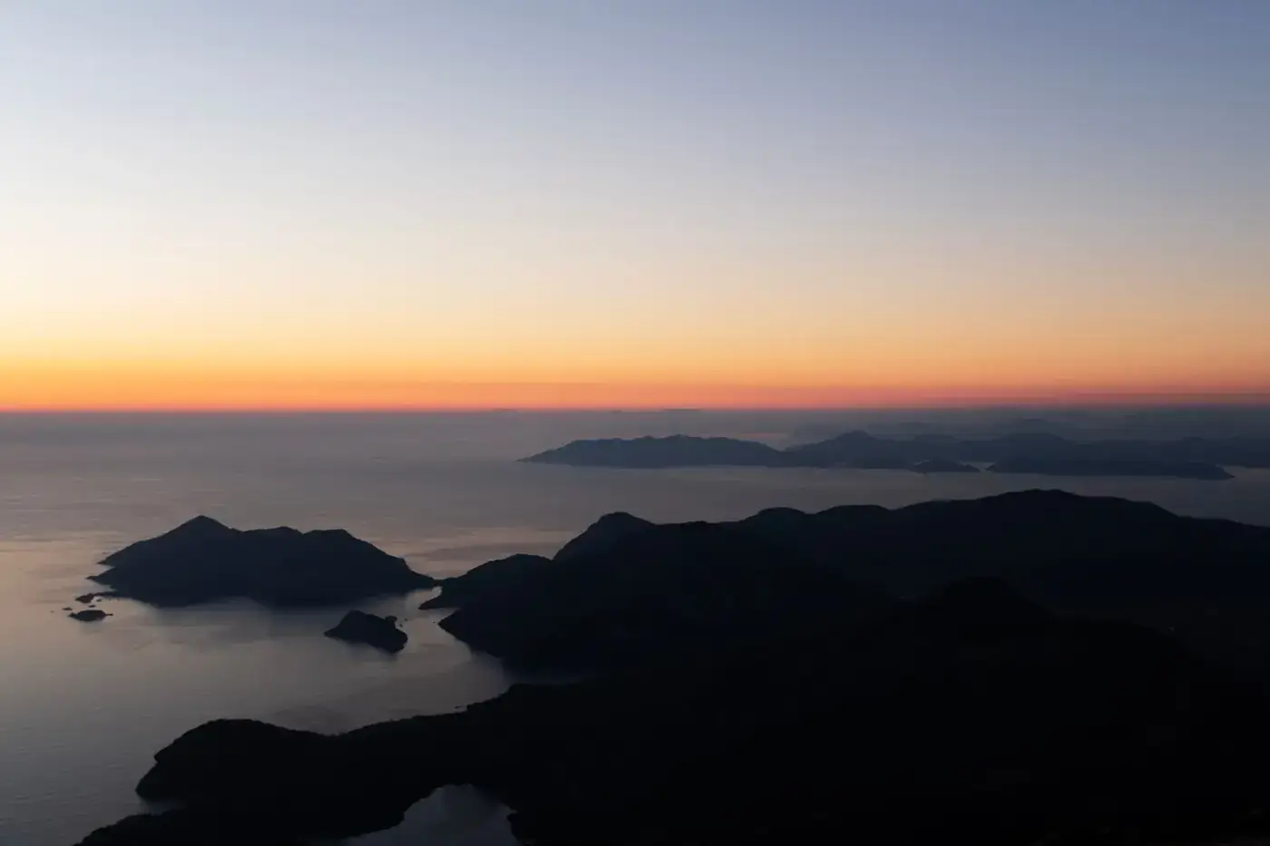 Stunning aerial view of Ölüdeniz, Türkiye, at sunset with vibrant colors over the sea.