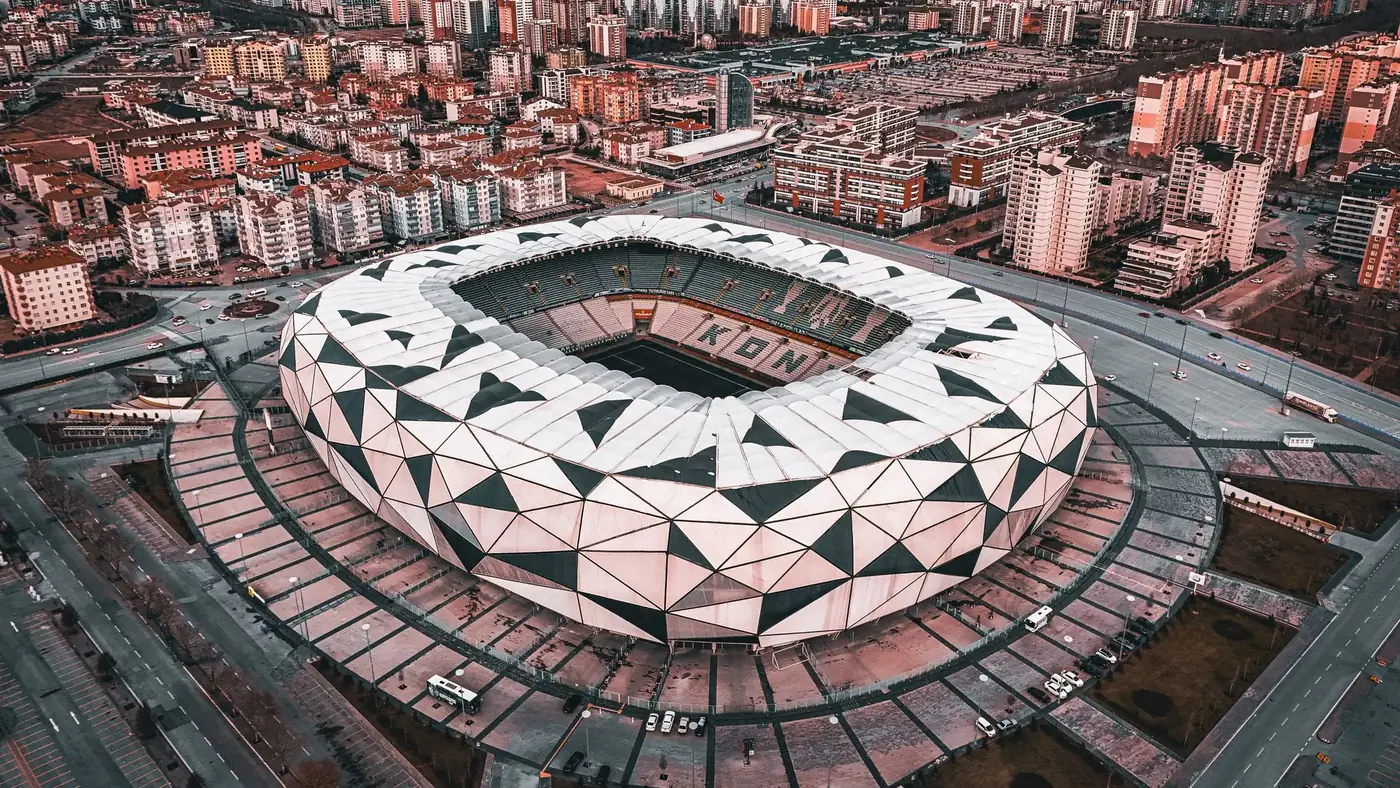 A stunning aerial view of the geometric design of Konya Stadium in Türkiye, showcasing urban architecture.