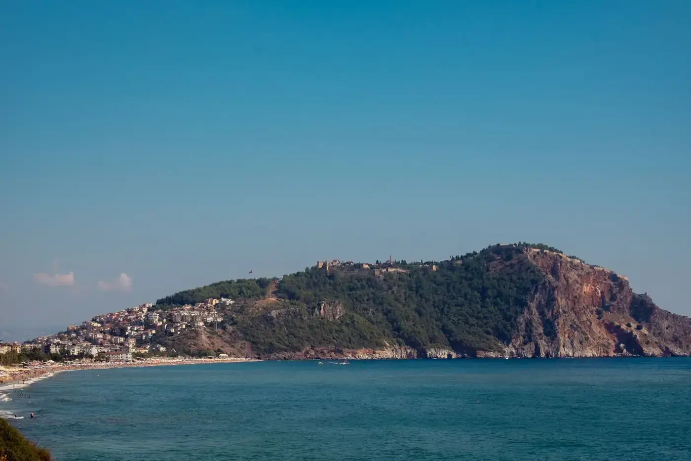 A breathtaking view of the Alanya Peninsula with clear blue skies and turquoise waters.