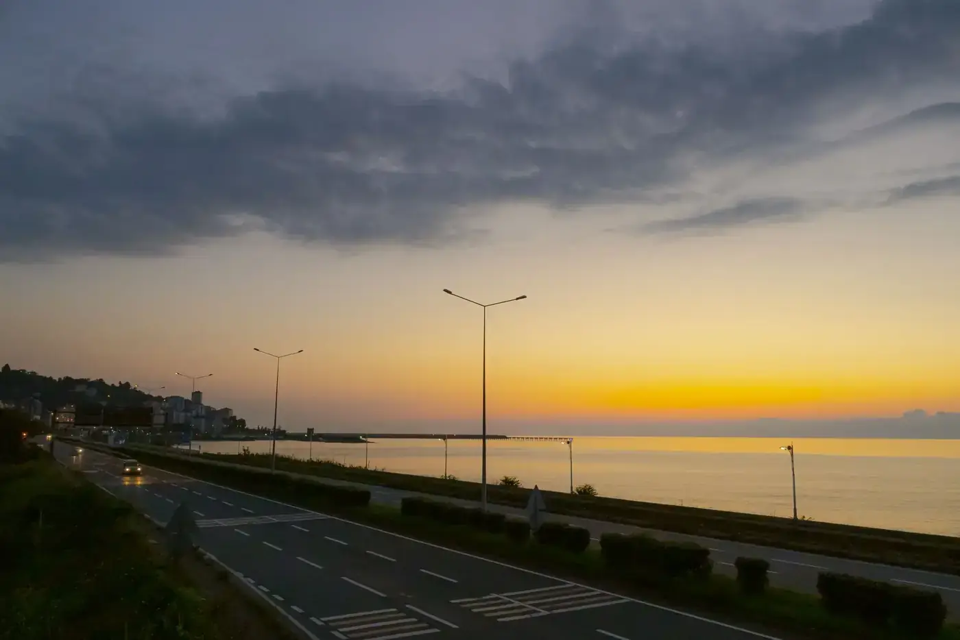 Scenic coastal road at sunset with a calm sea view in Pazar, Rize, Türkiye.